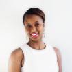 Black woman smiling, wearing a white shirt