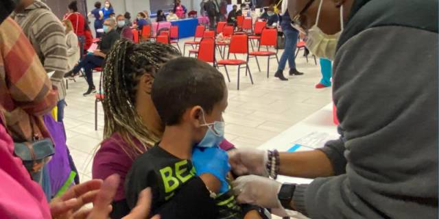 A family receives their shots at a Dia de la Mujer Latina COVID-19 vaccine clinic.