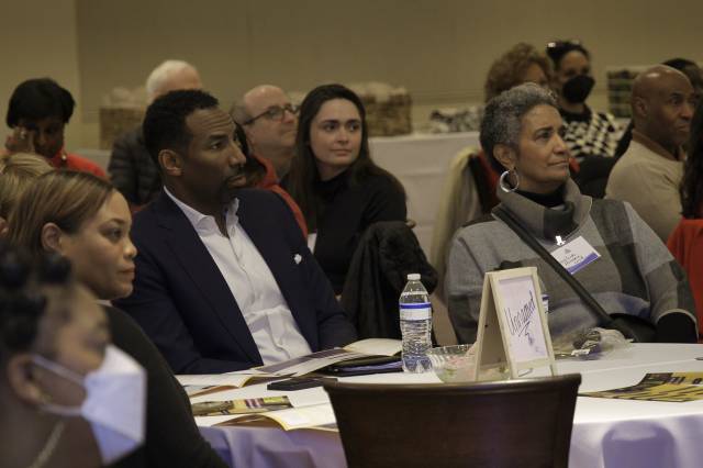 Mayor Andre Dickens sitting at a table