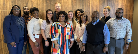 A group of people stands in the Foundation office.